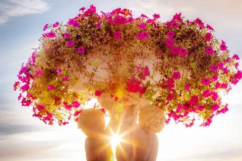 Sunrays between cherubins and flowers vase pot, Paris, France Stock Photos