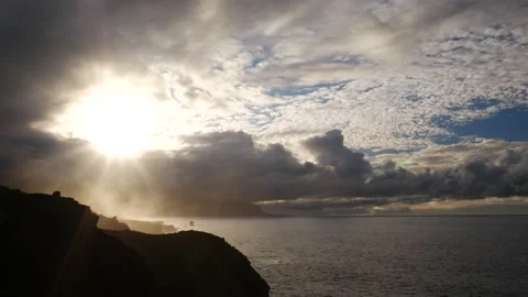 Sunrays breaking the clouds on a beautiful coastline 스톡 동영상 136827197