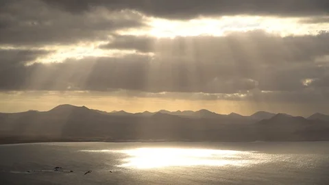 Sunrays coming through the clouds over the ocean at Lanzarote Island in Spain. Stock Footage 102626426