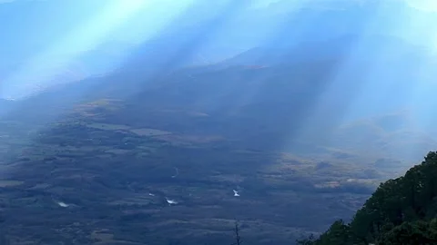 Sunrays in diagonal falling over hills at sunset Stock Footage 142708761