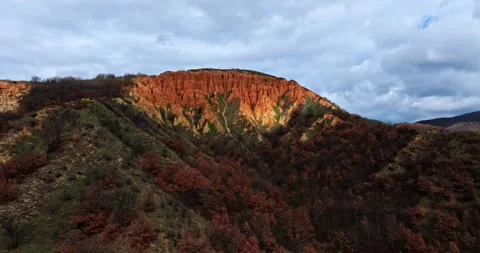 Sunrays Illuminating Mountain Ridge Sand Clay Erosion Clouds Zoom Out Video stock 300475743