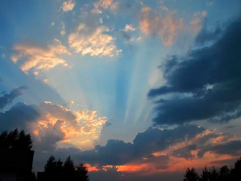 Sunrays over sunset sky Stock Photos