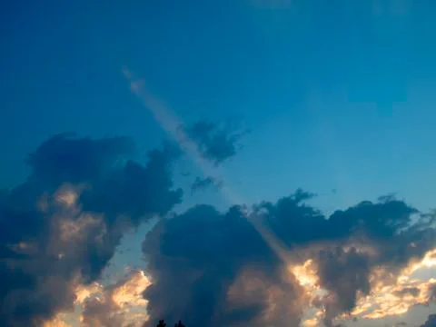 Sunrays over sunset sky Stock Photos