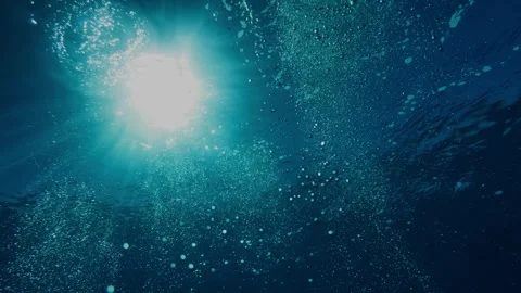 Sunrays piercing through Mauritius waters as bubbles rise toward the surface Stock Footage 338000955