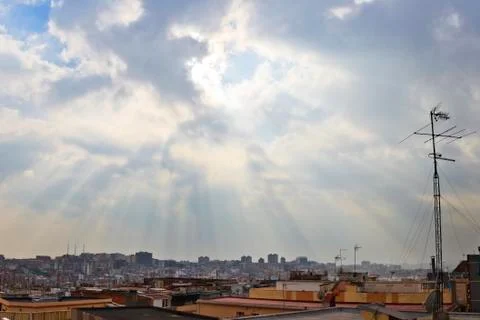 Sunrays through the clouds over Santa Coloma de Gramenet, Barcelona Stock Photos