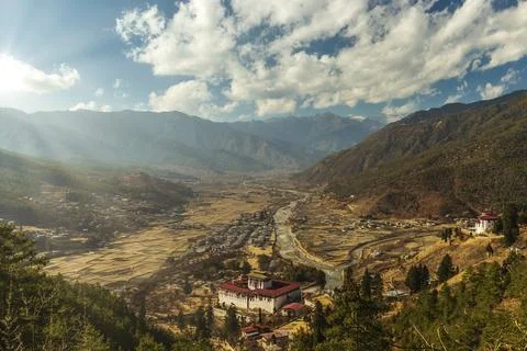 Sunrays through the clouds as the sun is setting over Paro Stock-Fotos