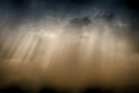 Sunrays under the dark clouds Stock Photos