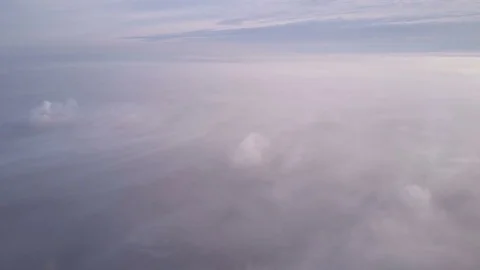 Sunrise above clouds from airplane window.  Stock Footage 84600513