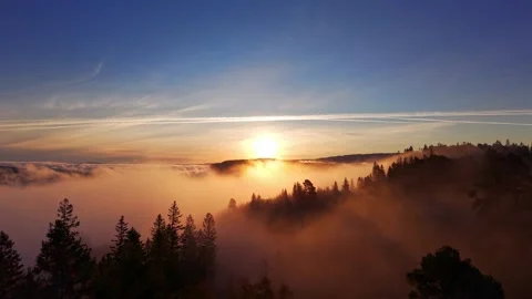 Sunrise Above the Clouds Over Misty Mountains in Norway Stock Footage 318829042