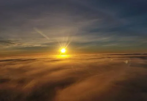 Sunrise above clouds Stock Photos