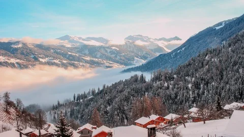 Sunrise above the mist in the small Swiss alpine village of Tschiertschen Stock Footage