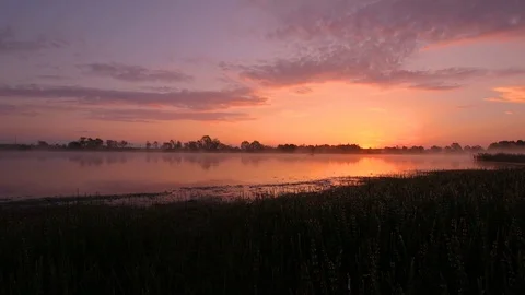 Sunrise above the pond with cloudy sky at summer. Stock Footage 108858572