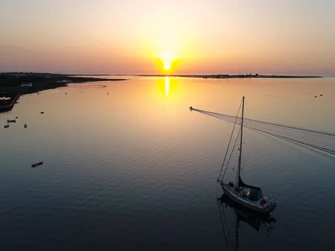 Sunrise aerial seascape view of Olhao dockyard waterfront. (Shot E - Boat Forw) Stock Footage