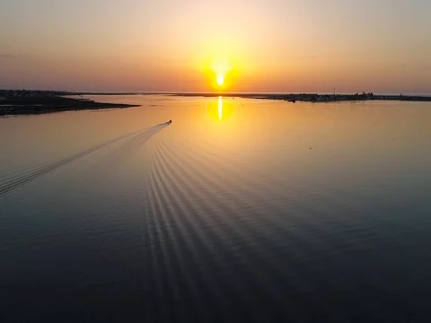 Sunrise aerial seascape view of Olhao dockyard waterfront. (Shot F - Boat Back) Stock Footage