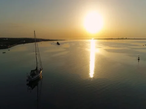 Sunrise aerial seascape view of Olhao dockyard waterfront. (Shot J - Boat Forw) Stock Footage
