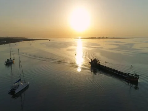 Sunrise aerial seascape view of Olhao dockyard waterfront. (Shot L - Boat Pan) Stock Footage