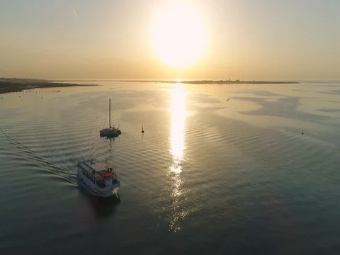 Sunrise aerial seascape view of Olhao dockyard waterfront. (Shot O - Boat Fly) Stock Footage