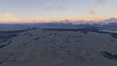 Sunrise aerial snow covered Grand Teton National Park in Wyoming. United States Stock Footage 330460153