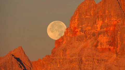 Sunrise and moon set  behind Croda rossa dolomites Stock Footage 128945548