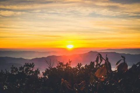 Sunrise backlit sky with cloud on the top of mountain Stock Photos
