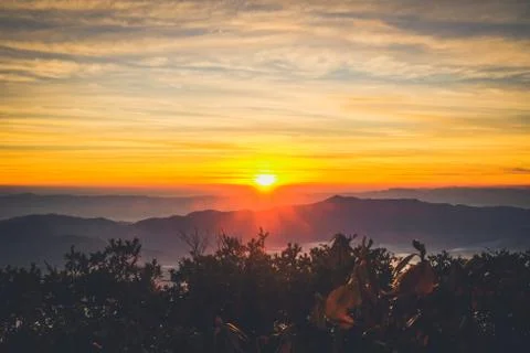 Sunrise backlit sky with cloud on the top of mountain Stock Photos
