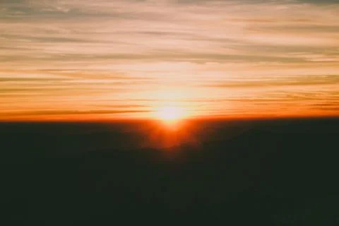 Sunrise backlit sky with cloud on the top of mountain Stock Photos