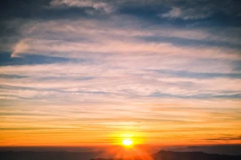 Sunrise backlit sky with cloud on the top of mountain Stock Photos