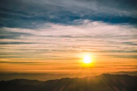 Sunrise backlit sky with cloud on the top of mountain Foto stock