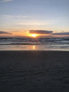 Sunrise at beach with clouds Stock Photos
