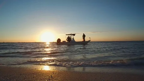 SUNRISE ON BEACH, SMALL BOAT, NET THROW Stock Footage 72631300