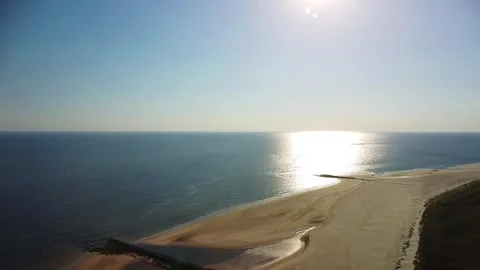 Sunrise on the beach with waves and soft light in the morning sky Stock Footage 339938646