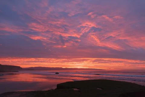Sunrise at the beach with waves Stock Photos