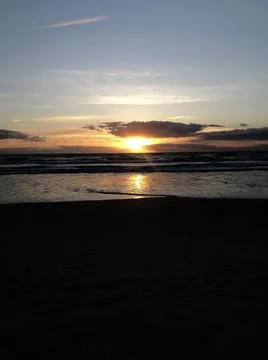 Sunrise behind clouds Stock Photos