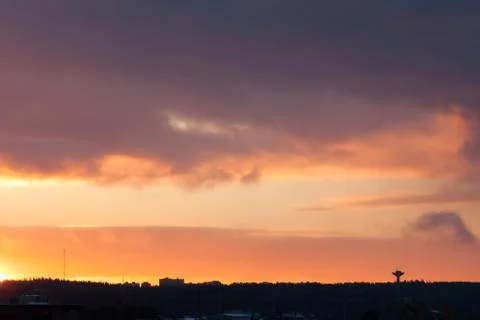 Sunrise behind clouds scene Stock Photos