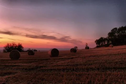 The sunrise behind the haystack Stock Photos