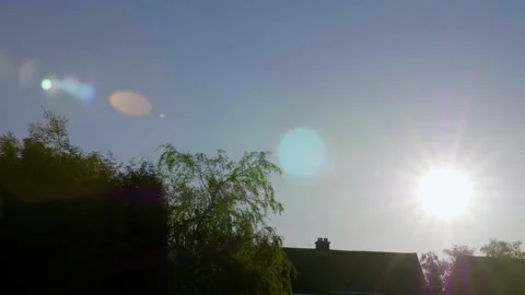 Sunrise from behind a house Stock Footage 131570421