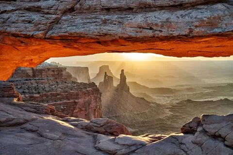 Sunrise behind Mesa Arch in Canyonlands National Park Stock Photos