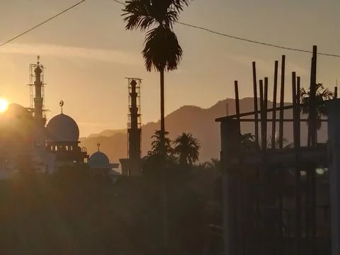 Sunrise behind the mosque Stock Photos