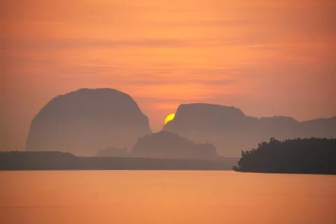 Sunrise behind the mountain range Stock Photos