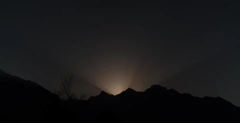 Sunrise behind a mountain timelapse Stock Footage 247132502