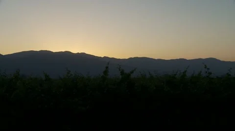 Sunrise from behind the mountains Video stock 64971535