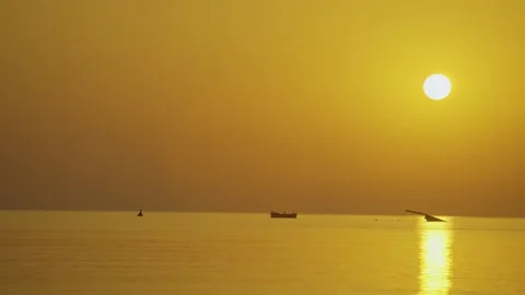 The sunrise behind a shipwreck in the ocean Stock Footage 286103136