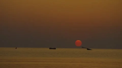 Sunrise behind a shipwreck in the ocean Stock Footage 286103404