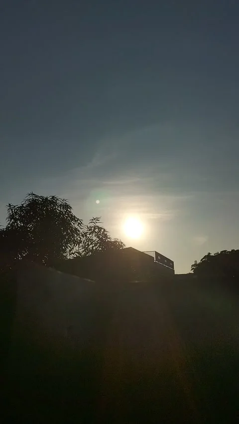 Sunrise Behind Trees and Rooftop with Clear Morning Sky Stock Footage 308399580