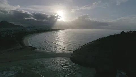 Sunrise between clouds, stone, beach, sand and sea. Stock Footage 81070361