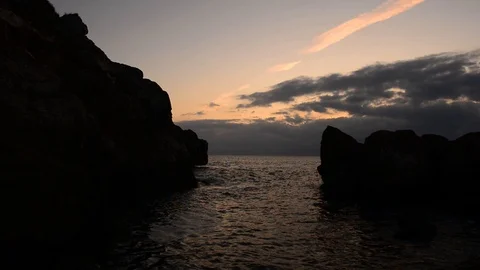 Sunrise between rocks and the Oropesa Sea Stock Footage 116774245