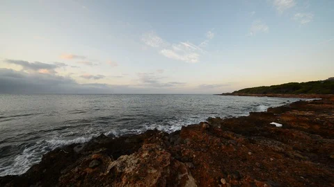 Sunrise between rocks and the Oropesa Sea Stock Footage 116774692