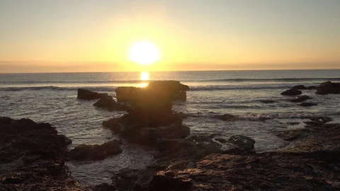 A sunrise between the rocks of Oropesa del Mar Stock Footage 103307184