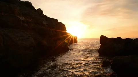 Sunrise between the rocks of the renega in Oropesa Stock Footage 133870831