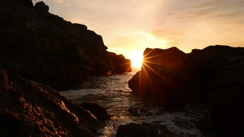 Sunrise between the rocks of the renega in Oropesa Stock Footage 133870856